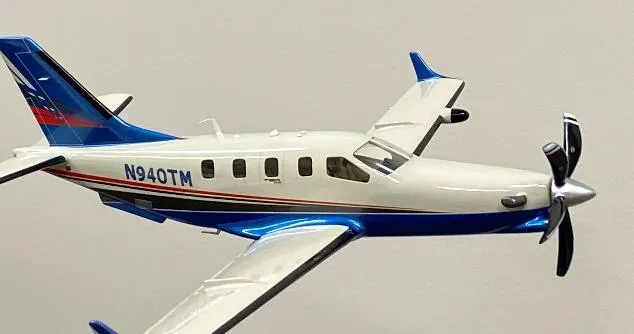 Small airplane flying over wilderness terrain