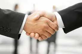 Business handshake representing M&A transaction protection